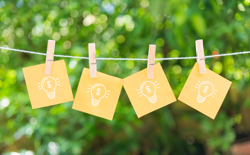 Post it notes with ideas to make money on a clothesline